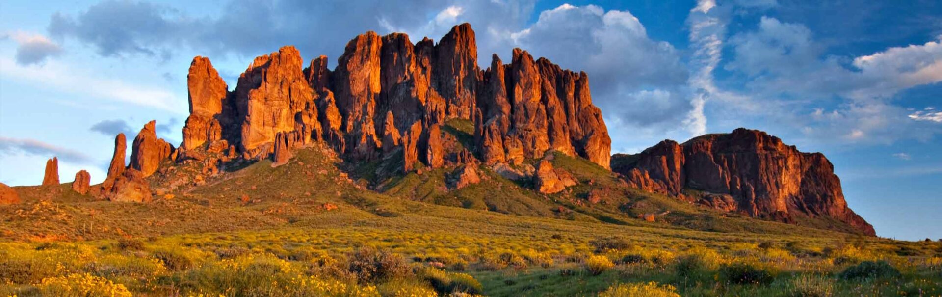 i-do-nothing-but-love-avvRANuWKkQ-unsplash A large red mesa rising out of the plains